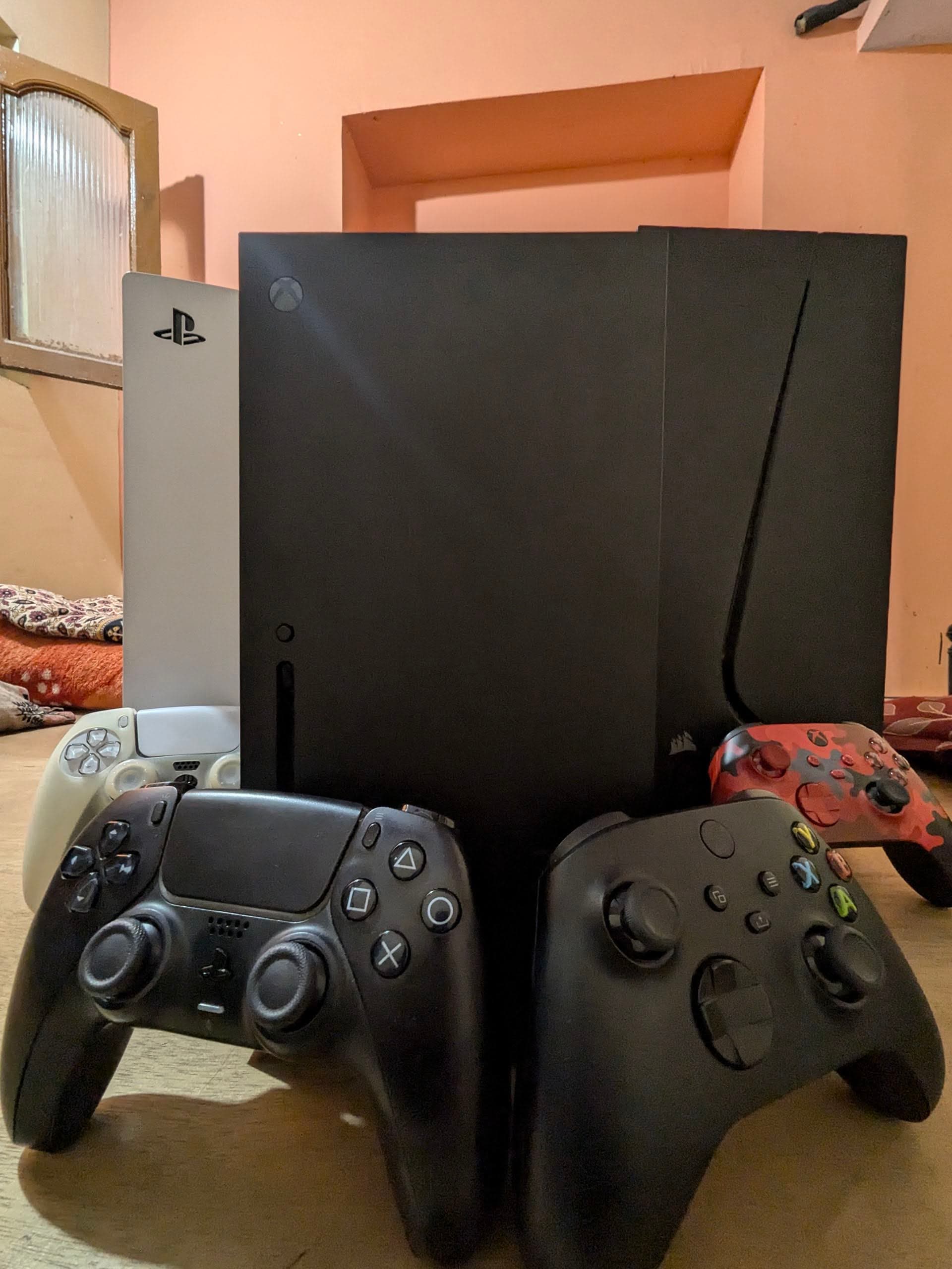 Gaming setup showing PS5, Xbox Series X, and PC together in one space